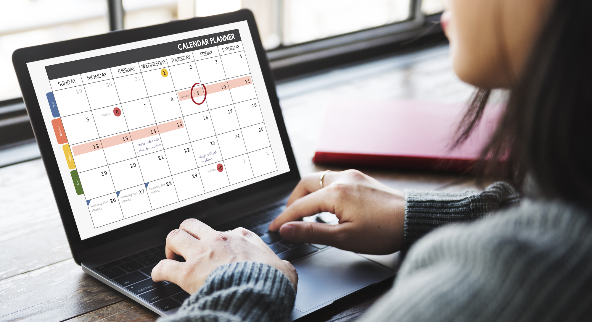 woman on a laptop with the calendar view on it